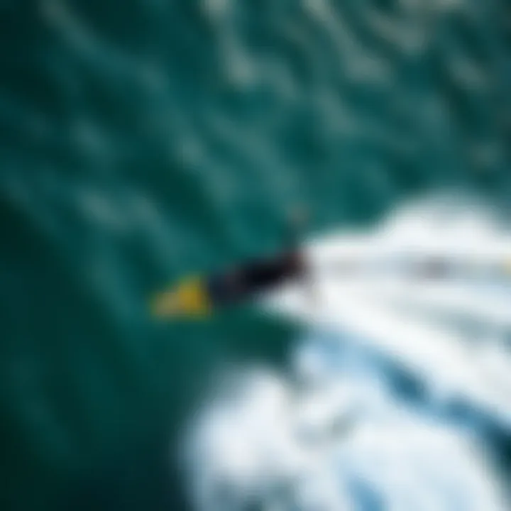 Rider Gliding Above Water on Wing Foil Board An aerial shot of a rider gliding effortlessly above the water on a wing foil board.