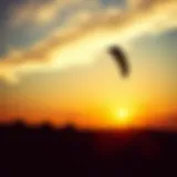 Dynamic shot of a controllable kite soaring against the backdrop of a sunset
