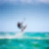 A kiteboarder executing a chop hop maneuver above the water surface