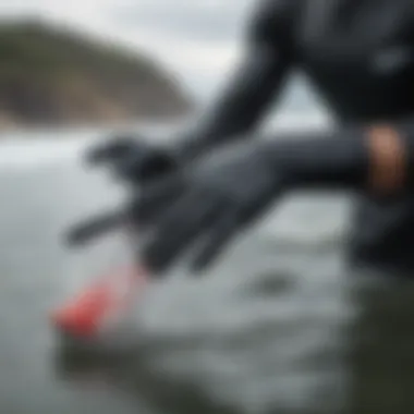 Surfer wearing surf gloves in cold water