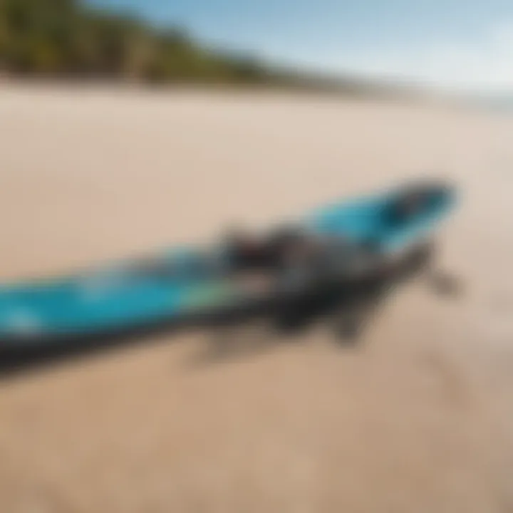 A close-up of essential kiteboarding gear laid on the sandy beach