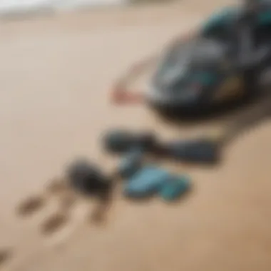 Close-up of kiteboarding gear laid out on the sandy beach