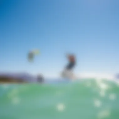 Kiteboarders gliding effortlessly across the water under a clear blue sky, showcasing the vibrant sport.
