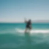 A kiteboarder gliding across the turquoise waters of Tarifa