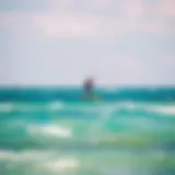 Kiteboarder gliding over turquoise waters