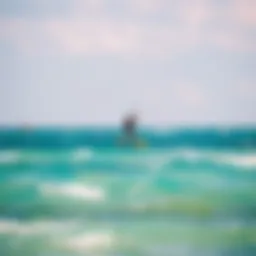 Kiteboarder gliding over turquoise waters