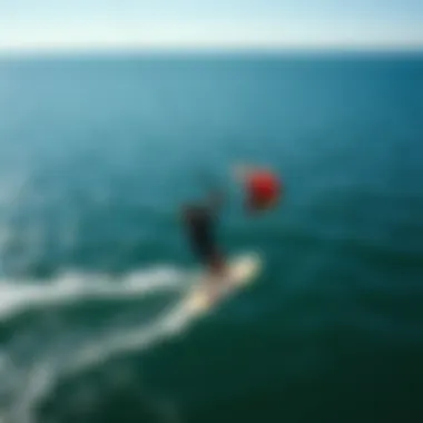 Aerial View of Foil Kiteboarding in Action An aerial perspective of a foil kiteboarder gliding over water