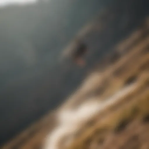 Kiteboarder gliding over a rugged mountain terrain