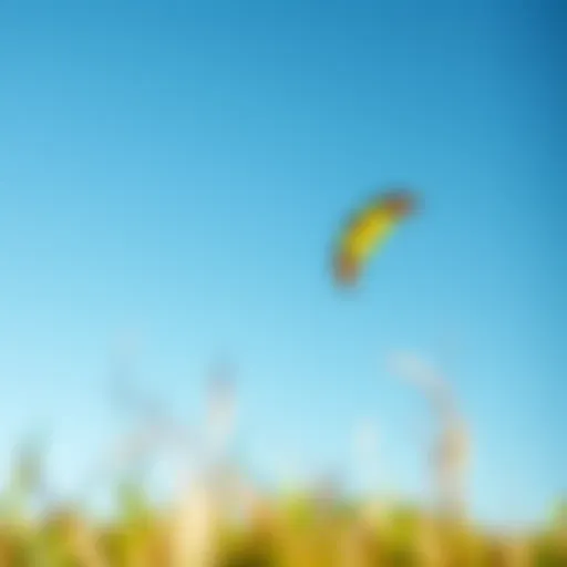 A vibrant kiteboarding kite soaring high against a clear blue sky