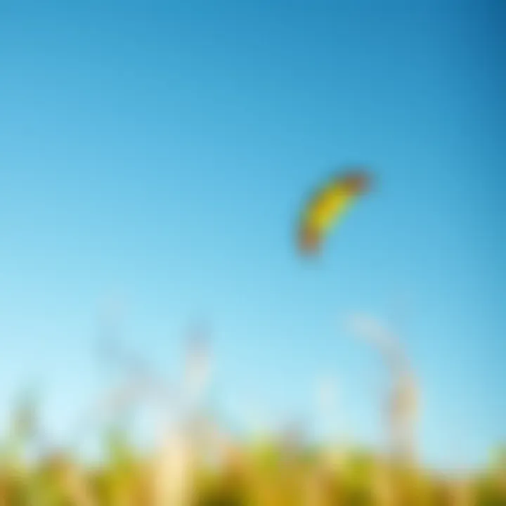A vibrant kiteboarding kite soaring high against a clear blue sky