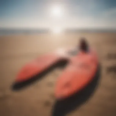 Close-up of high-quality wing surfing equipment laid out on a sandy beach