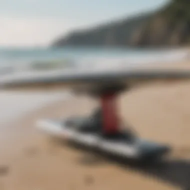 Close-up of specialized wingfoiling equipment laid out on a beach