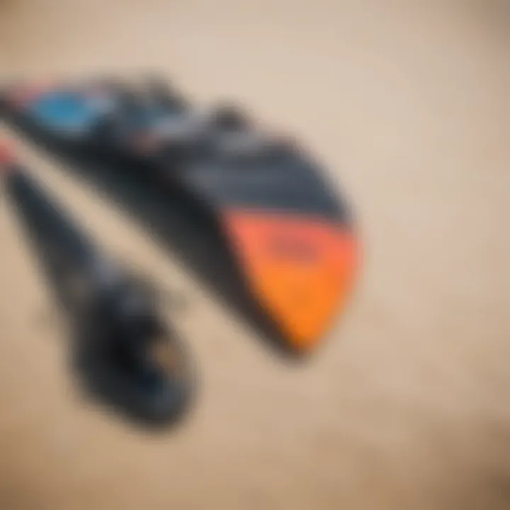 Close-up of kite surfing gear laid out on the sand