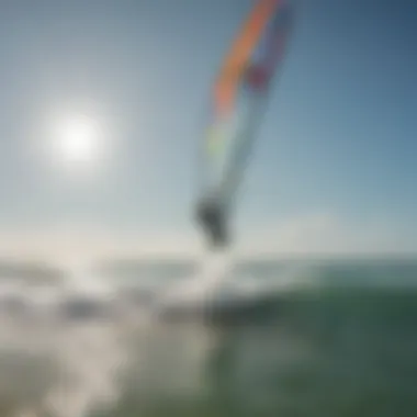 Kite surfer gliding over vibrant waves under a clear sky