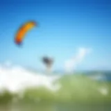 A vibrant kite soaring high above the ocean waves