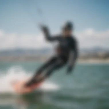 Kiteboarder wearing thin neoprene gloves while riding