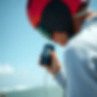 Portable Wind Speed Measurement for Riders A kiteboarder checking wind speed with a portable device