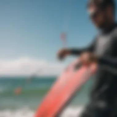 A kiteboarder adjusting lines on a kite before launching