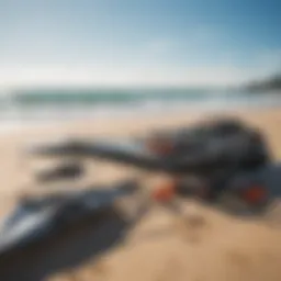 A comprehensive kitesurfing gear setup displayed on a sandy beach.