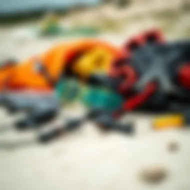 Essential Gear for Kiteboarding A collection of essential kiteboarding gear laid out on the beach.