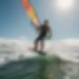 Kiteboarder gliding through waves with a vibrant kite