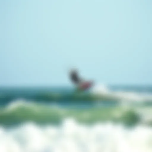 Kiteboarder gliding over ocean waves at Sagamore Beach