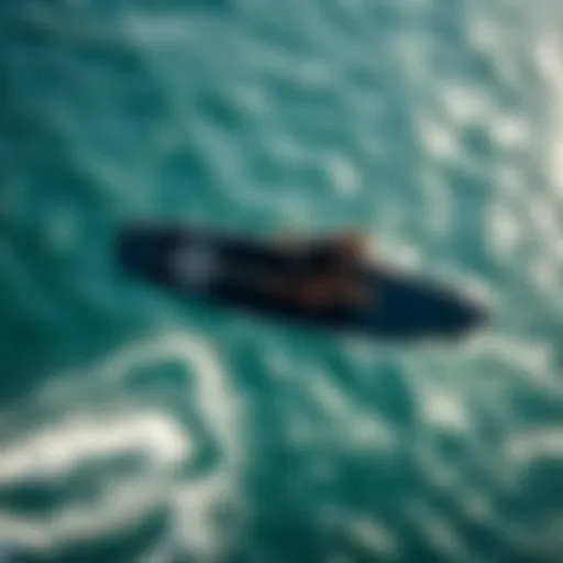 An aerial view of a sup wing foiler gliding over water