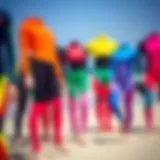 Colorful kiteboarding wetsuits displayed on a beach