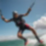 A kiteboarder soaring high above the water, showcasing remarkable air time.