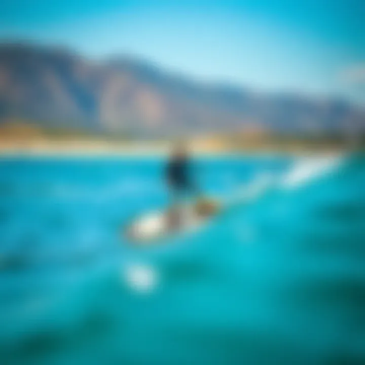 Rider in Action on Foil Board A scenic view of a rider gliding over water on a foil board
