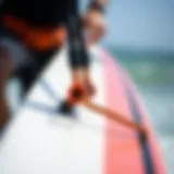 Close-up of a kiteboard leash attached to a board