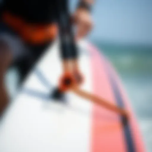 Close-up of a kiteboard leash attached to a board