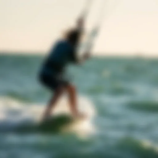 Kiteboarder riding a wave under clear skies