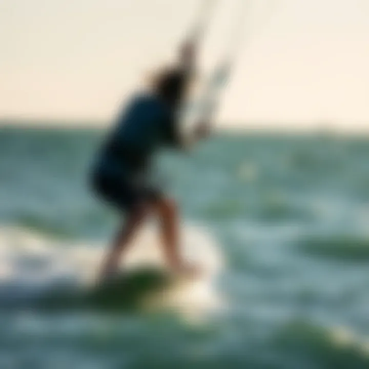 Kiteboarder riding a wave under clear skies